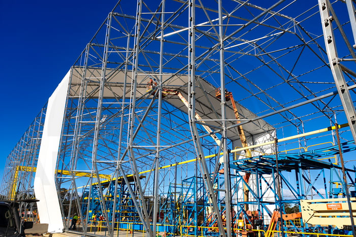 image of installing the fabric on the pre-cast fabric building